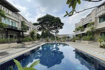 Outdoor pool area with surrounding buildings