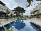 Outdoor pool area with surrounding buildings