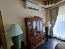 Living room with wooden cabinet and air conditioner