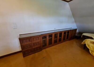 Long wooden cabinet in a bedroom