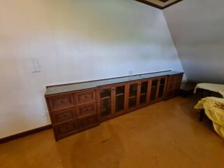 Long wooden cabinet in a bedroom