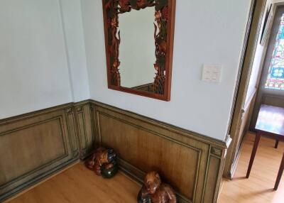 Decorative hallway with mirror and wooden sculptures