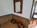 Decorative hallway with mirror and wooden sculptures