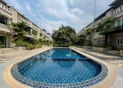 outdoor swimming pool area with surrounding buildings