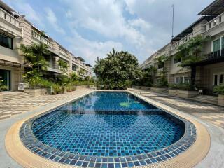 outdoor swimming pool area with surrounding buildings