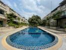 outdoor swimming pool area with surrounding buildings