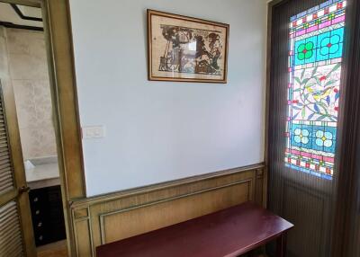 Small room with a table near a stained glass window