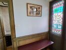 Small room with a table near a stained glass window