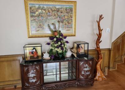 Living room area with decorative cabinet and framed artwork