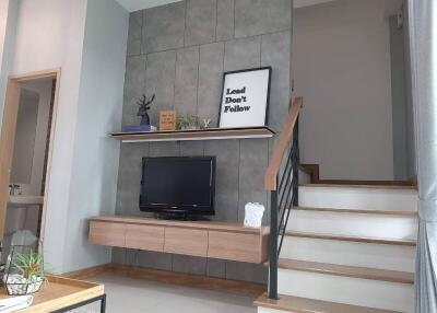 Modern living area with TV and staircase