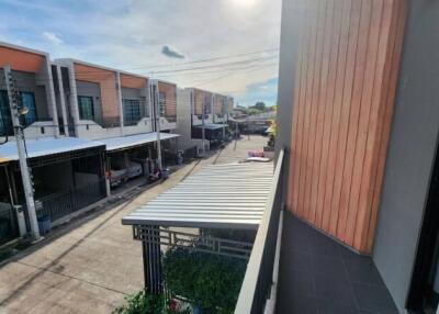 View from balcony overlooking street with modern townhouses