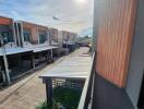 View from balcony overlooking street with modern townhouses