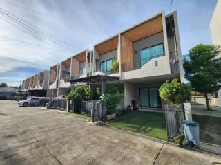 Row of modern townhouses with front yards