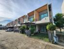 Row of modern townhouses with front yards