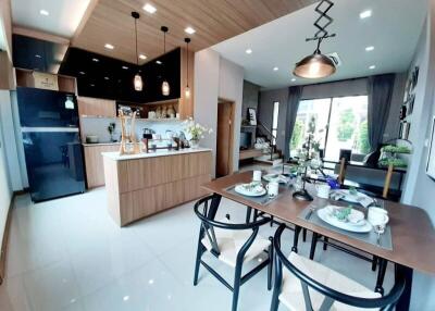 Modern open-plan living area featuring a kitchen, dining, and lounge