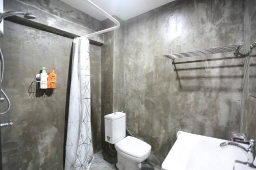 Modern bathroom with concrete walls