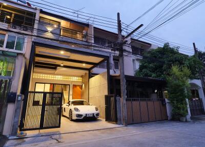 Front view of a multi-story residential building with a garage