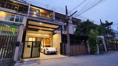 Front view of a multi-story residential building with a garage