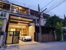 Front view of a multi-story residential building with a garage