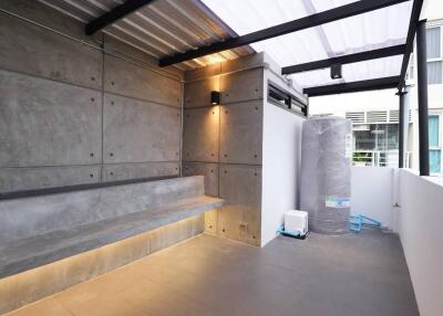 Modern balcony with concrete bench and partial view of neighboring buildings