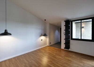 Modern living room with wooden floor and pendant lighting