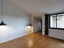 Modern living room with wooden floor and pendant lighting