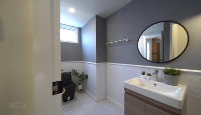 Modern bathroom with window, sink, and plants