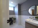 Modern bathroom with window, sink, and plants