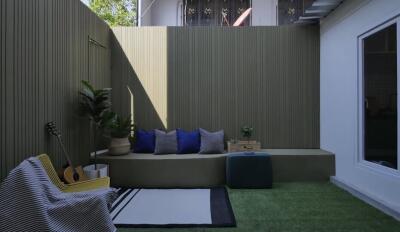 cozy outdoor lounge area with seating and plants