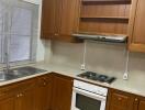 A kitchen with wooden cabinets and white appliances