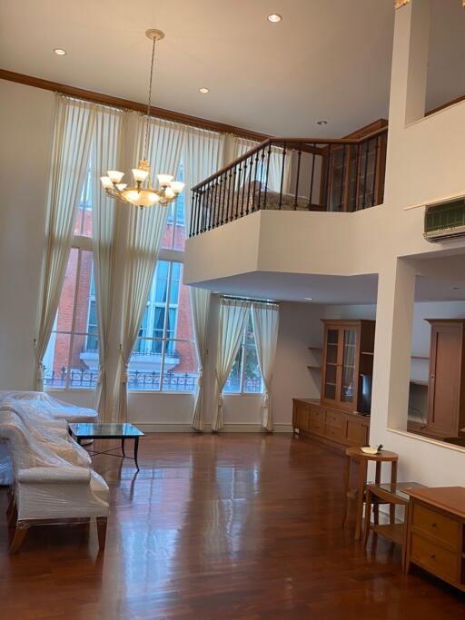 Spacious living room with high ceilings and large windows