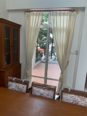 Living room with wooden furniture and a view to the patio