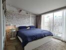 Modern bedroom with a large window and exposed brick wall