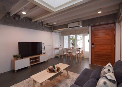 Modern living room with high ceiling and large windows