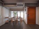 Modern, cozy dining area with wooden door and air conditioning