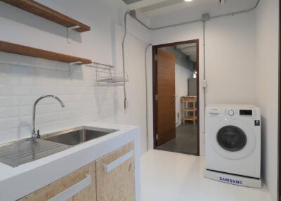 Laundry room with sink and washing machine