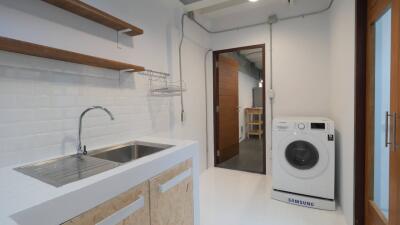 Laundry room with sink and washing machine