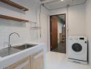 Laundry room with sink and washing machine