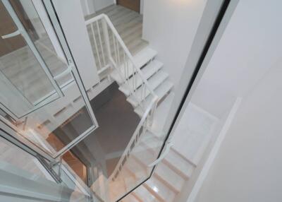 Modern white staircase with glass railing