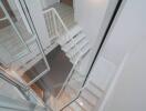 Modern white staircase with glass railing