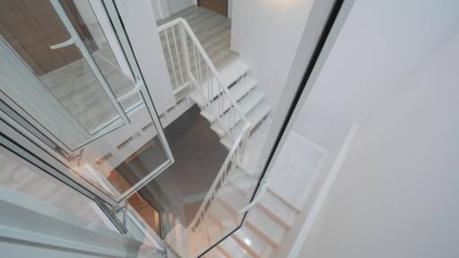 Modern white staircase with glass railing