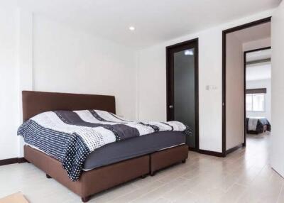 Modern bedroom with double bed and open doorway