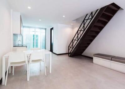 Bright living room with dining area and staircase