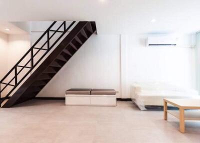 Modern living room with stairs and minimalistic furniture