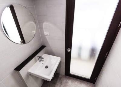 Bathroom with a modern sink and frosted glass door