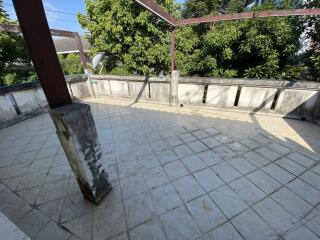 Spacious open balcony with tiled flooring and partial covering