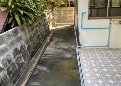 Narrow outdoor walkway beside building