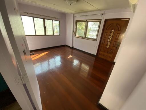 Empty room with hardwood floors and natural light