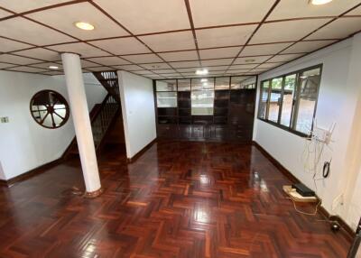 Spacious living room with wooden floor and large windows