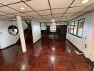 Spacious living room with wooden floor and large windows